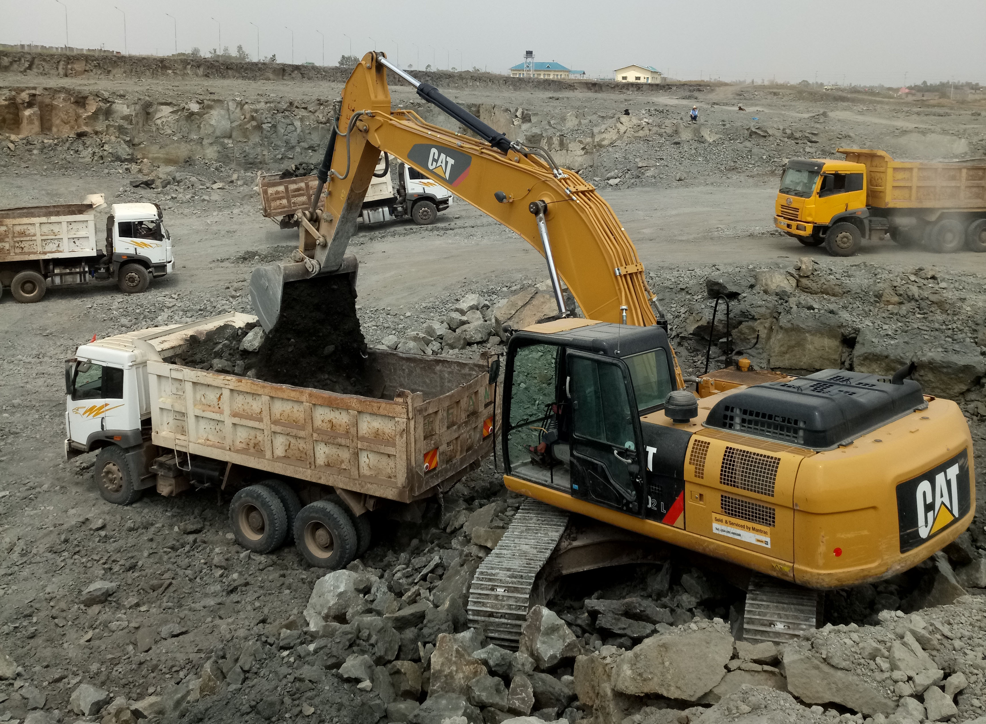 Cat excavator loading a dump truck