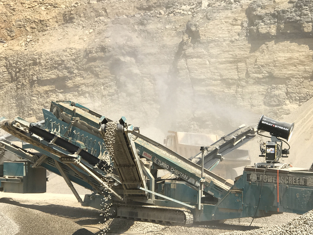 A Spraystream system fitted to a three-way split screener in operation at a quarry in Germany