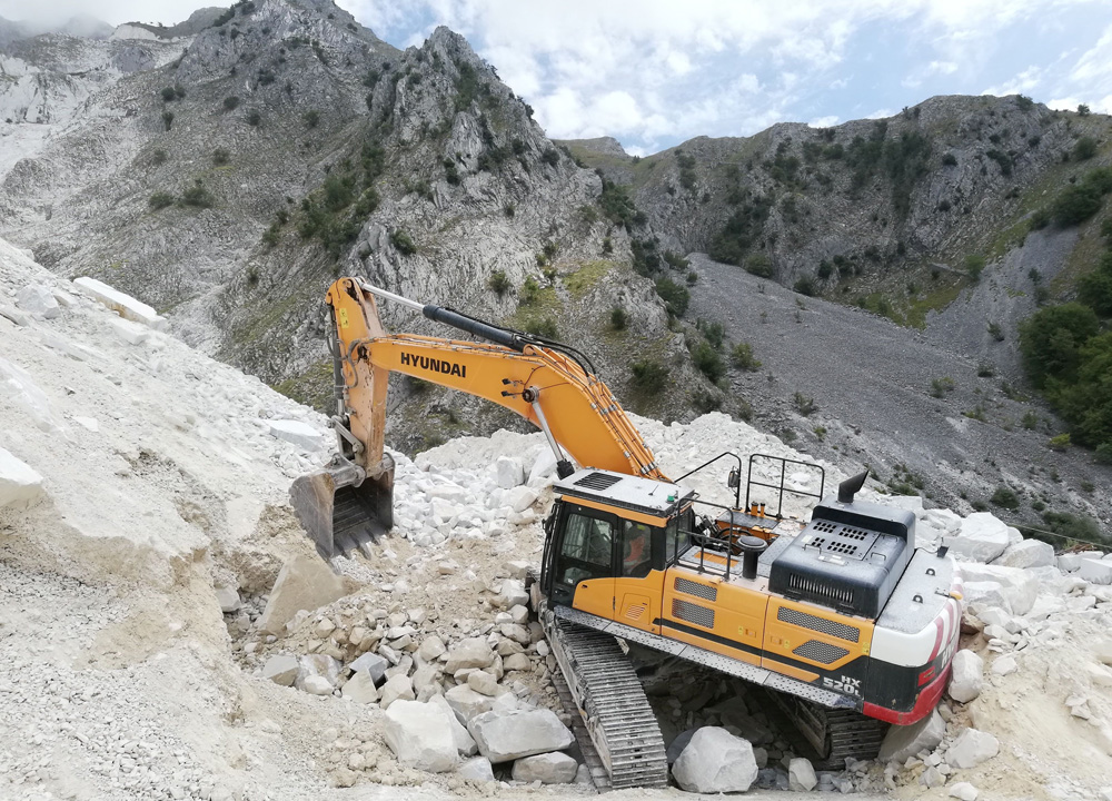 A Hyundai HX520L excavator working at the Colonnata marble quarry in Tuscany
