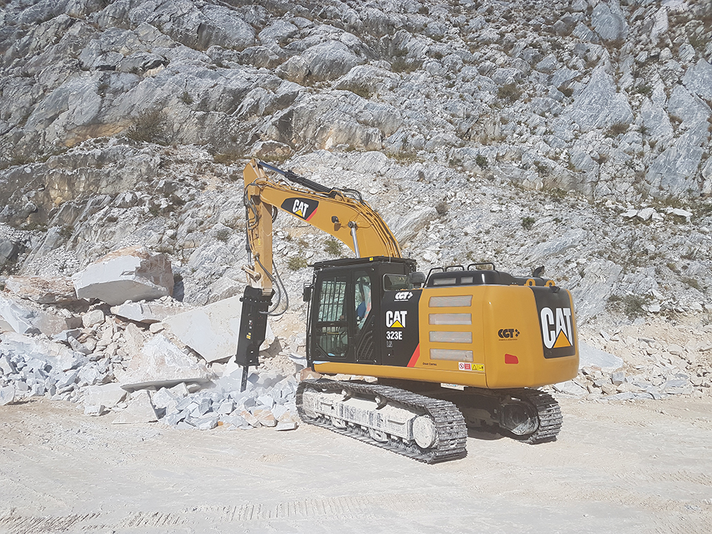 A Cat hammer deployed to break rock in a quarrying application