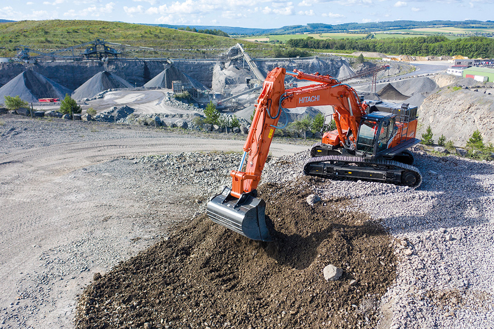A Hitachi ZW220-7 wheeled loader loading quarried material into a truck