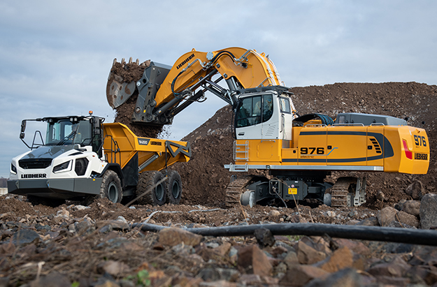 A new Liebherr R 976-E electric crawler excavator loading material into an articulated hauler