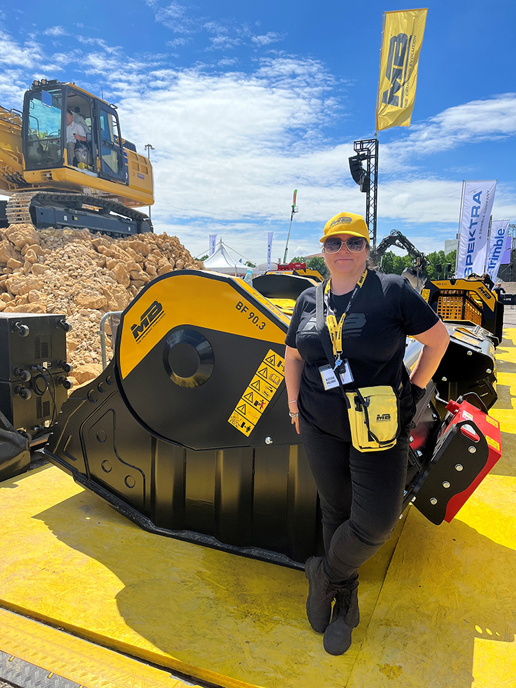 Alessia Valerio, MB Crusher communications manager on the company's outdoor stand and demo area at SaMoTer 2023