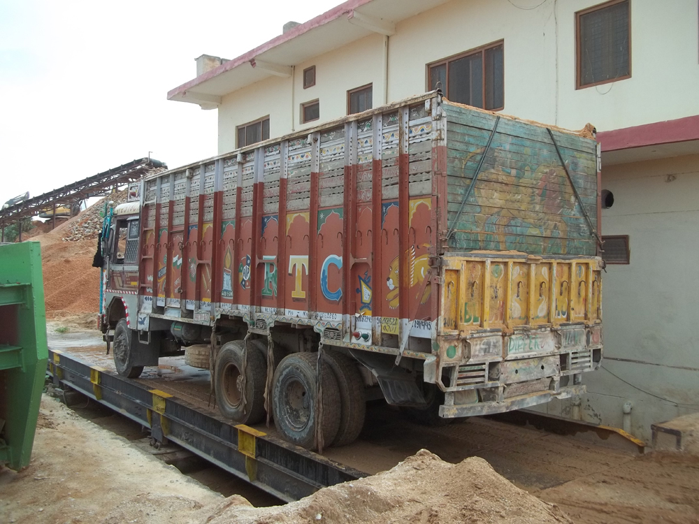 A truck having its sand payload weighed at an Indian minerals processing facility prior to setting off on a customer delivery  