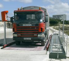 Truck having its load weighed on a weighbridge