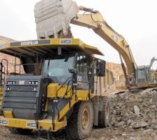 The Cat 775G trucks are loaded by the new Cat 390DL excavator
