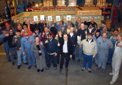 JCI employees celebrate the shipment of its 3,000th screen
