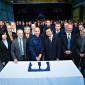 Guests and personnel gathered for the cake cutting ceremony as Komatsu UK 